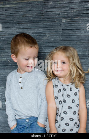 Little boy and little girl standing side by side, portrait Stock Photo