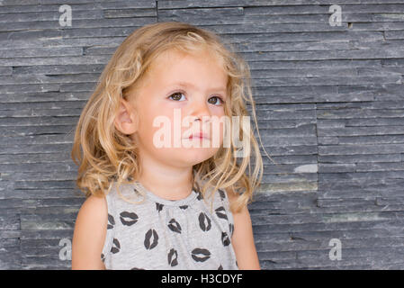Little girl looking up in thought, portrait Stock Photo