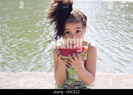 Girl eating watermelon outdoors Stock Photo