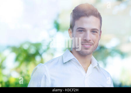 Businessman looking out of window from office Stock Photo