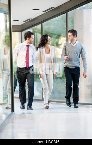 Business team members brainstorming while on the move Stock Photo