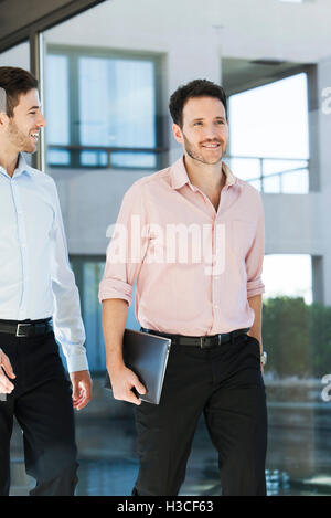 Business associated walking together in office Stock Photo