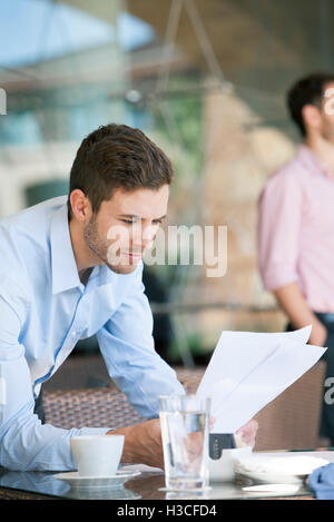 Businessman reviewing documents Stock Photo