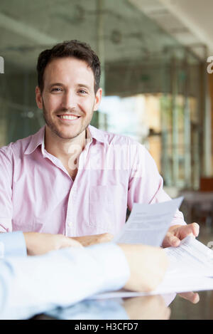 Man reviewing documents with financial advisor Stock Photo