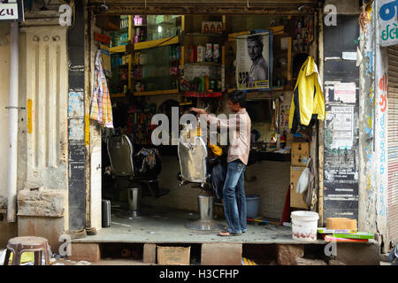 JUNAGADH, GUJARAT, INDIA - JANUARY 18: Man shaving off second at the makeshift hairdressing unit on one of streets in India