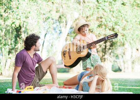 Parents teaching son how to play guitar Stock Photo