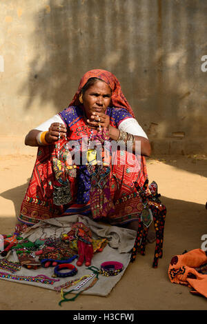 BHUJ, RAN OF KUCH, INDIA - JANUARY 14: The tribal woman in the traditional dress selling souvenirs for tourists