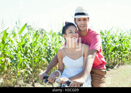 Couple riding bike together Stock Photo
