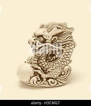 Netsuke of east dragon, which guarding the egg. A miniature sculpture, which was used as a button-like trinket in traditional Ja Stock Photo