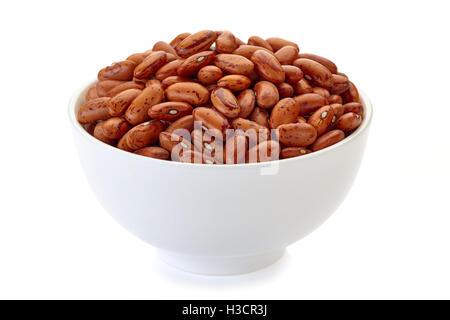 Bowl with pinto beans on white Stock Photo