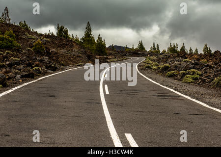 Road in volcanic desert Tenerife, Canary. Asphalt and white line on road Stock Photo