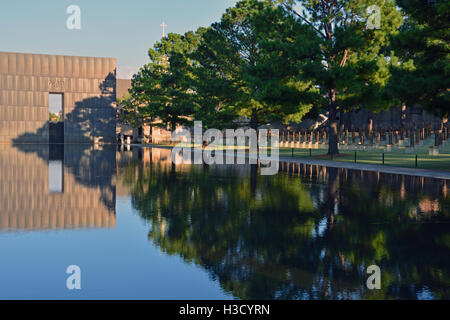 The reflecting pool, 9:01 Gate, and memorial chairs at the Oklahoma City National Monument. Stock Photo