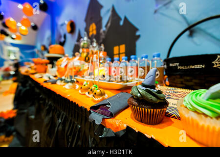 Halloween Birthday Buffet with Candy and Cupcakes all with Special Halloween Designs Stock Photo