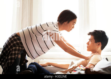Side view of romantic woman leaning on man sitting at home Stock Photo