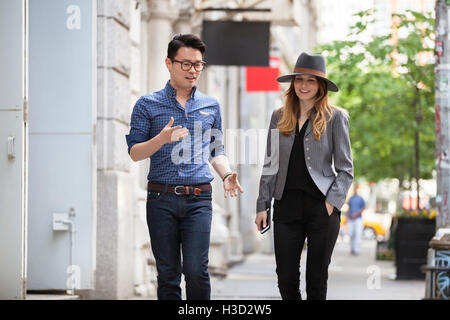 business people walking on sidewalk in city Stock Photo