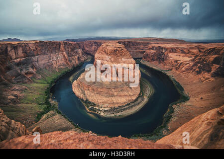 Scenic view of Horseshoe Bend against cloudy sky Stock Photo