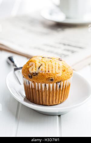 The tasty muffin with chocolate on white table. Stock Photo
