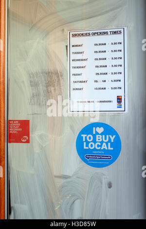 out of business cafe window blanked out with polish england uk Stock Photo