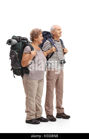 Full length profile shot of two elderly hikers looking in the distance isolated on white background Stock Photo