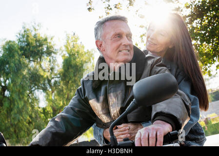 Senior couple taking a ride on a motorcycle. Stock Photo