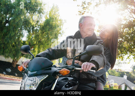 Senior couple taking a ride on a motorcycle. Stock Photo