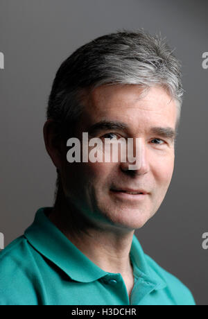 Informal portrait of mature man 50-56 yrs in natural light wearing casual sports shirt Stock Photo