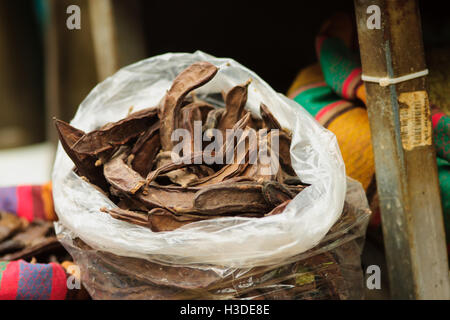 Carob pods on sale in the market Stock Photo