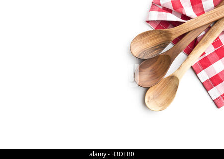 Three wooden spoons and checkered napkin isolated on white background. Top view. Stock Photo