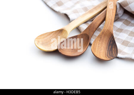 Three wooden spoons and checkered napkin isolated on white background. Stock Photo
