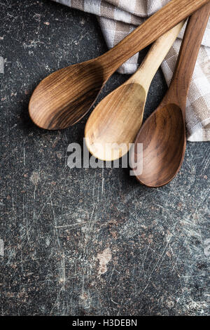Handmade wooden spoons on old kitchen table. Top view. Stock Photo