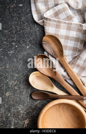 Wooden spoons and bowl on old kitchen table. Top view. Stock Photo