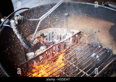 A charcoal barbecue being cleaned Stock Photo