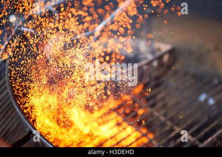 A charcoal barbecue being cleaned Stock Photo