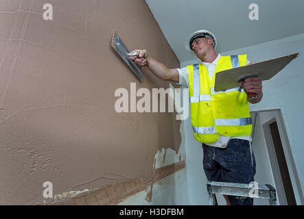 Plasterer working on a building site Stock Photo