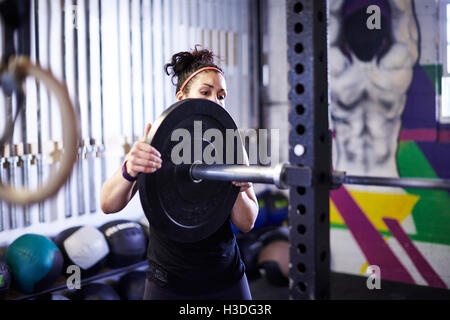 A female athlete trains in a crossfit gym. Stock Photo