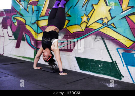 A female athlete trains in a crossfit gym. Stock Photo