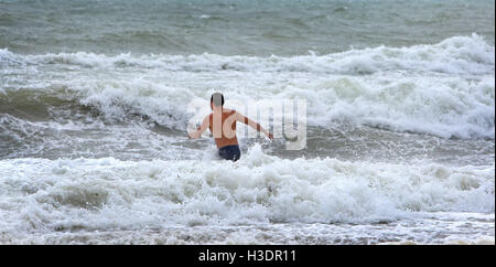 Hollywood, FL, USA. 6th Oct, 2016. Alex Werner of Aventura goes for a last minute swim on Hollywood Beach as Hurricane Matthew approaches South Florida. Credit:  Sun-Sentinel/ZUMA Wire/Alamy Live News Stock Photo