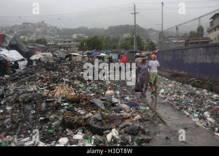 (161006) -- PORT-AU-PRINCE, Oct. 6, 2016 (Xinhua) -- Image provided by the United Nations Children's Fund (UNICEF) shows people walking near piles of garbage after the arrival of hurricane Matthew, in Port-Au-Prince, capital of Haiti, Oct. 4, 2016. Hurricane Matthew has left at least 108 people dead in Haiti, according to the interior ministry on Thursday. (Xinhua/UNICEF) (da) (ce) ***MANDATORY CREDIT*** ***NO SALES-NO ARCHIVE*** ***EDITORIAL USE ONLY*** Stock Photo