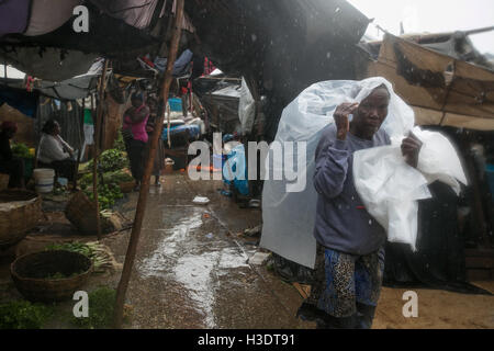 (161006) -- PORT-AU-PRINCE, Oct. 6, 2016 (Xinhua) -- Image provided by the United Nations Children's Fund (UNICEF) shows a person walking in rain after the arrival of hurricane Matthew, in Port-Au-Prince, capital of Haiti, Oct. 4, 2016. Hurricane Matthew has left at least 108 people dead in Haiti, according to the interior ministry on Thursday. (Xinhua/UNICEF) (da) (ce) ***MANDATORY CREDIT*** ***NO SALES-NO ARCHIVE*** ***EDITORIAL USE ONLY*** Stock Photo