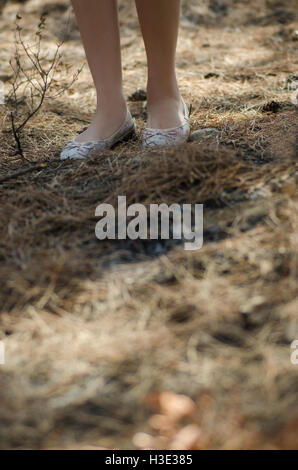 Close up of a young woman's feet walking in the woods Stock Photo