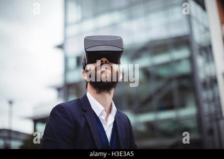 Businessman using virtual reality headset Stock Photo