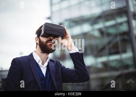 Businessman using virtual reality headset Stock Photo