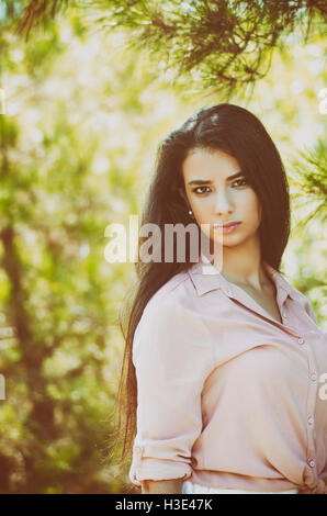 Serious young woman staring outdoors Stock Photo