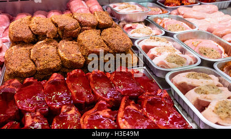 Variety of marinated meat at display counter Stock Photo