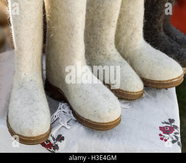 Warm shoes made of felt (felt boots) to work in the winter outdoors. Sold at the fair. Stock Photo