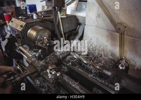 Mechanic working on a lathe machine Stock Photo