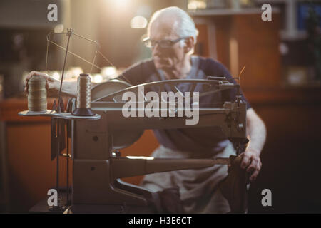 Shoemaker using sewing machine Stock Photo