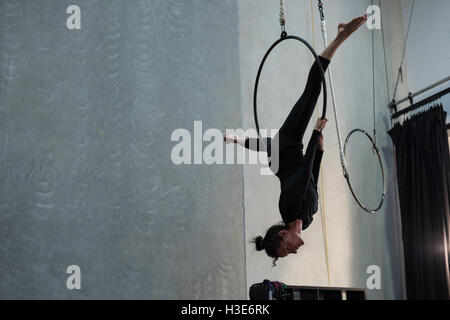 Gymnast performing gymnastics on hoop Stock Photo