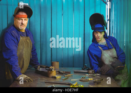 Portrait of male and female welder standing together Stock Photo