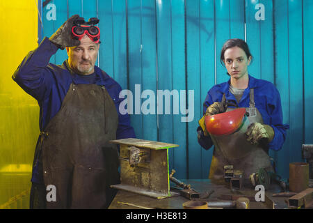 Portrait of male and female welder standing together Stock Photo